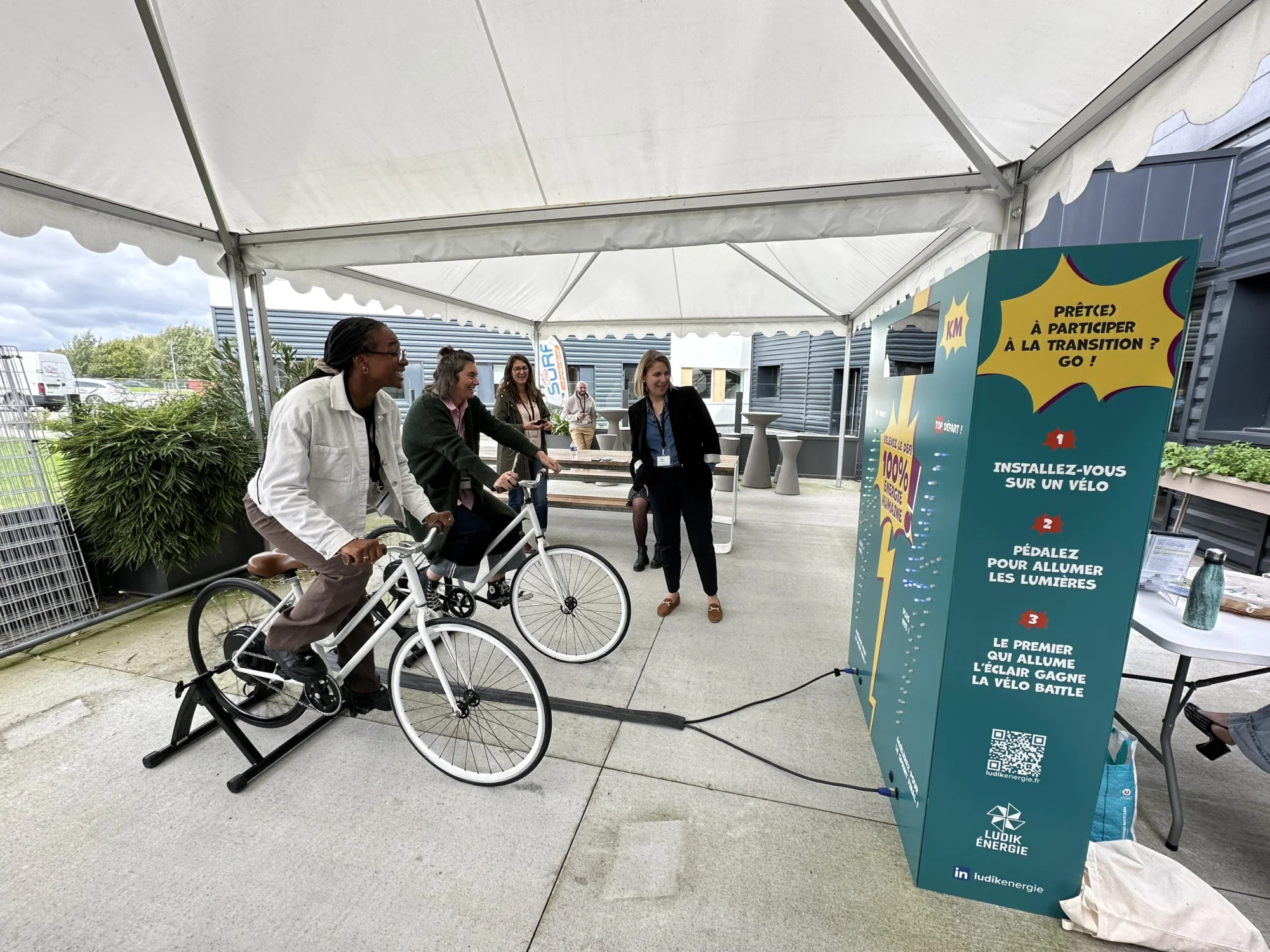 Deux employés d’une entreprise participent à une animation sportive Vélo Battle, à l’occasion d’un team building green.